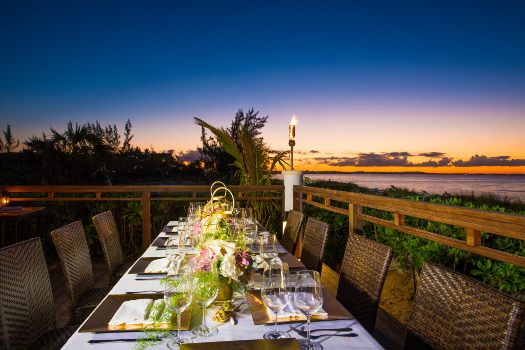 Restaurant Table Setup with Ocean Sunset in background