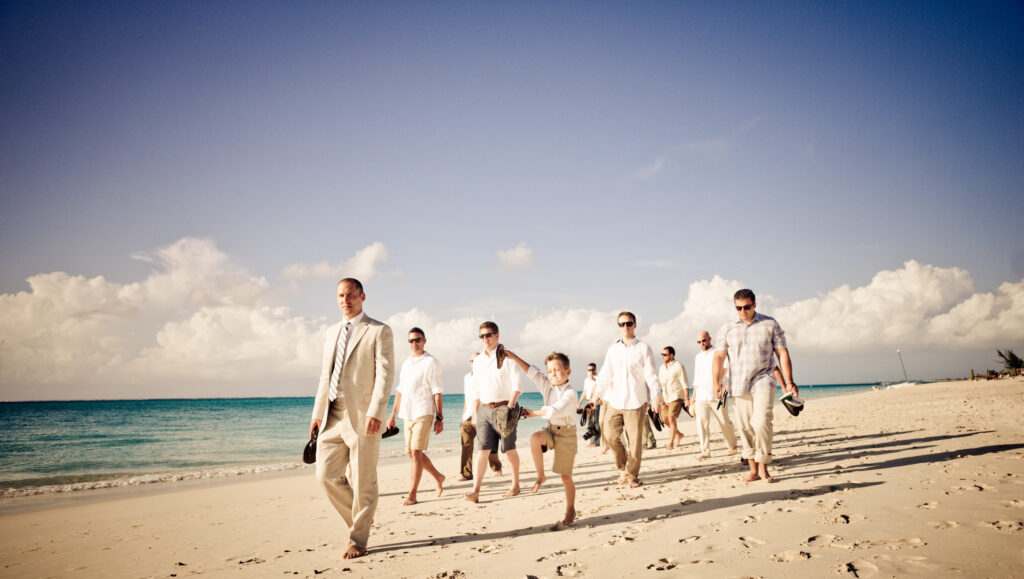 Family walking on beach after wedding