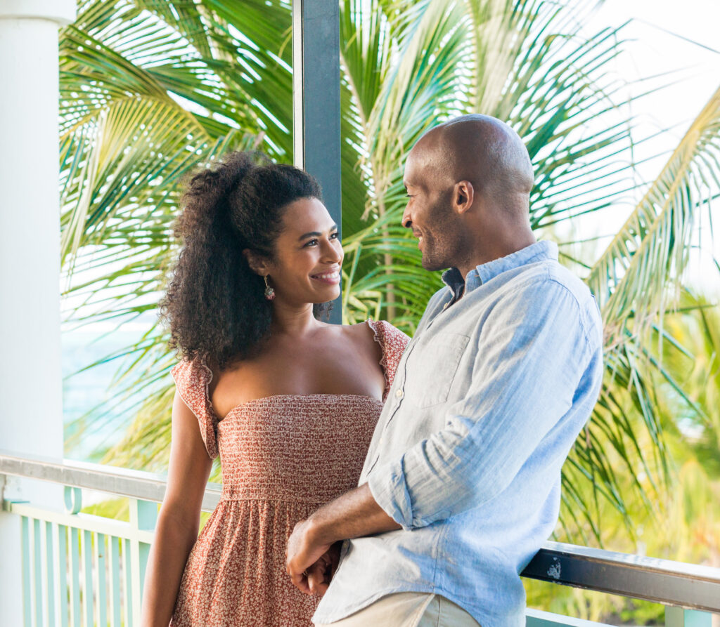 Couple Looking at Each Other with Palm Tree in Background