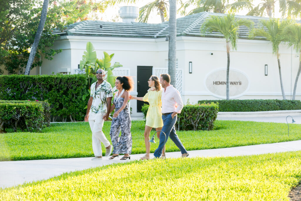 Two Couples Walking Together on Hotel Path