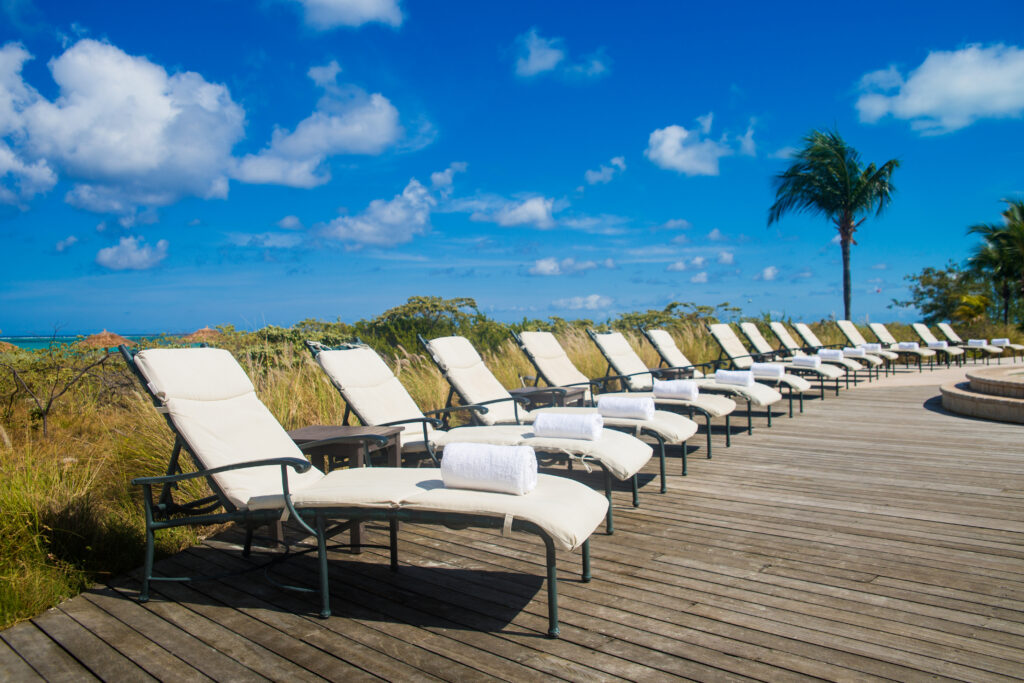 A line of pool chairs on the deck of the pool.
