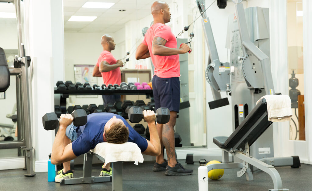Two men working on out in gym