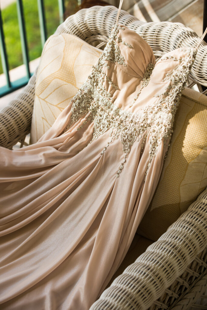 Wedding dress laying across hotel patio chair